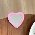 Detailed view of a pink glitter heart-shaped phone grip mirror with mi ne text branding - Deep Pink