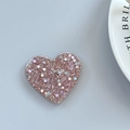 Macro view of rose gold heart phone grip featuring sparkling glitter and sequins - Adhesive Heart Stand - Light Chasing Dark Pink