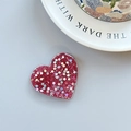 Macro shot of red heart-shaped phone grip with glitter and holographic sequins - Adhesive Heart Stand - Light Chasing Rose Red