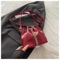 Detail der roten Beuteltasche aus glänzendem PU-Leder mit Kordelzug und Perlenverzierung - Rot