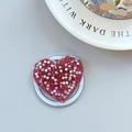 Macro detail of red glitter heart phone grip with sparkling sequins on light blue surface - Magnetic Heart Stand - Light Chasing Rose Red