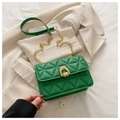 Detail of green quilted crossbody bag with golden horseshoe lock and chain strap - Green