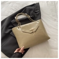 Detail der hellbeige Umhängetasche mit goldenem Hirsch-Anhänger und eleganter Kette - Dunkelkhaki
