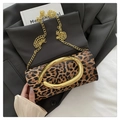 Close-up of leopard print evening clutch with gold oval handle and chain strap on blazer - Leopard Print