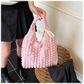 Pink popcorn fabric tote bag with white lace bow detail shown in lifestyle setting - Yellow