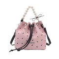 Chic pink bucket bag with black bow print, pearl handle, and adjustable shoulder strap - Solid Bow Decor Pink