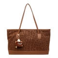 Große Shopper-Tasche mit Leopardenmuster, Lederriemen und Monster-Anhänger auf weißem Grund - Mit Anhänger / Braun