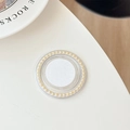 Detail view of a round Griptok phone holder with white pearls and gold accents - Yellow