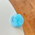 Detailed view of light blue bear phone grip with a semi-transparent resin texture - Blue