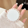 Close-up of minimalist Gingham pattern magnetic phone socket held in hand for grip - Orange