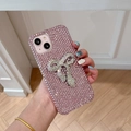 Detailed close-up of a pink rhinestone iPhone case with a luxury crystal bow ornament - Pink / iPhone 7/8/SE 2020