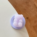 Detail view of a purple gummy bear phone grip with transparent resin finish for Magsafe - Light Purple