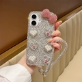 Close-up of luxury rhinestone phone case with pink bow, heart pearls and wrist strap - Rhinestone Heart Bow with Lanyard / Iridescent / Series 7/8/SE 2020