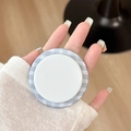 Hand holding a blue and white gingham folding phone grip for a steady grip and stand - Lake Blue