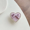 Close-up of heart-shaped rhinestone phone stand with purple leather and polka dot bow - Transparent Stand - Purple