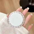 Close-up of magnetic phone grip with light purple plaid pattern on white background - Brown