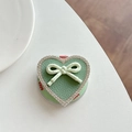 Macro detail of heart-shaped phone grip with green leather texture and rhinestone edge - GD Magnetic - Green