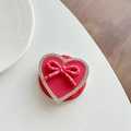 Macro detail of heart-shaped phone grip with leather texture, bow, and rhinestones - GD Magnetic - Rose Red