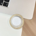 Close-up of a round rhinestone phone grip holder with sparkling champagne crystals - Yellow