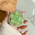 Detail of magnetic phone grip featuring a light green sequin flower and pearl edges - Pearl Magnetic Sugar Sequin Cherry Blossom / Green