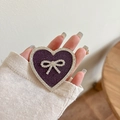 Close-up of a purple glitter heart phone grip featuring a rhinestone bow accent - Transparent Stand - Rhinestone Heart Bow - Star Diamond - Purple
