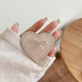 Detail of pink leather heart phone socket with rhinestone bow and sparkling crystals - Transparent Stand - Rhinestone Heart Bow - Pearlescent - Pink