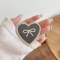 Close-up of glittery heart phone grip with rhinestone bow detail held in hand - Transparent Stand - Rhinestone Heart Bow - Pearlescent - Gray