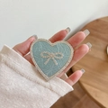 Close-up of heart-shaped phone grip with blue texture, white rhinestones and a bow knot - Transparent Stand - Rhinestone Heart Bow - Pearlescent - Blue