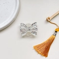 Macro shot of glittery butterfly phone grip with silver sequins and clear resin finish - Expanding Stand / Silver