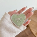 Close-up of heart-shaped phone grip with mint green leather and rhinestone bow detail - Transparent Stand - Rhinestone Heart Bow - Pearlescent - Green