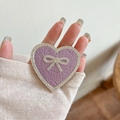 Macro view of purple faux leather heart phone stand with rhinestones and bow detail - Transparent Stand - Rhinestone Heart Bow - Pearlescent - Purple