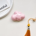 Detail shot of pale pink cloud phone socket holder with glossy ceramic-like finish - Airbag Holder - Pink