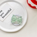Macro detail of green glitter butterfly phone socket stand on a ceramic plate - Magnetic Airbag Stand / Green