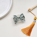 Detail of butterfly phone grip featuring colorful sequins and transparent resin design - Expanding Stand / Black