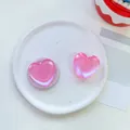Detail view of pink pearlescent heart phone socket on creative ceramic plate decor - Transparent Stand / Matte Heart-Iridescent Pink