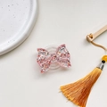 Detail of pink glitter bow magnetic phone grip with resin texture on white background - Expanding Stand / Red