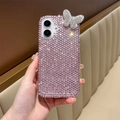 Detail of pink rhinestone iPhone case with a silver crystal butterfly and hand strap - Acrylic Pink Rhinestone Butterfly Case / iPhone 17 Pro Max