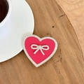 Close-up of heart-shaped phone grip in pink leather with rhinestone bow on wood desk - Transparent Stand-Rhinestone Heart Bow-Leather Texture-Rose Red