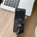 Detailed macro view of the black cross-texture leather case with a camellia bow for Z Flip - Samsung ZFlip3 / Cross Grain Camellia Bow Wristband-Black
