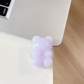 Close-up of a translucent purple gummy bear phone grip stand on a white desk - Light Jelly Light Purple