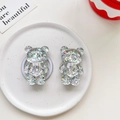 Macro detail of 3D bear-shaped glitter phone grips on a stylish ceramic display tray - Bear - Colorful Sequins - No. 16