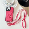 Detail of dark pink leather iPhone case featuring a card holder with adjustable strap - Rose Red / iPhone 17 Promax