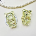 Macro detail of bear phone grip with sparkling glitter sequins and pearl necklace decor - Bear - High-Shine Sequins - Yellow