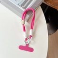 Detail of a thick magenta braided phone lanyard with white metal rings and a tether pad - Rose Red