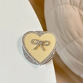 Macro shot of heart phone grip with yellow leather texture and rhinestone bow detail - Magnetic Rhinestone Heart Bow-Leather Texture / Yellow