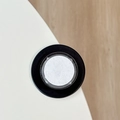 Vertical view of a minimalist round magnetic phone socket with black and white layers - Black