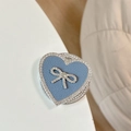 Detail of blue leather heart phone grip with sparkling rhinestones and a bow accent - Magnetic Rhinestone Heart Bow-Leather Texture / Grey Blue