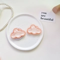 Detailansicht von zwei glitzernden rosa Wolken-Handyhalterungen auf einem Dekoteller - Magnetischer Ständer / Perlglanz Wolke-Orange