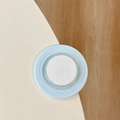 Close-up of light blue soft silicone corner protector applied to a wooden table edge - Mint Green