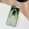 Detail of mint green textured leather phone case with wrist strap and metal accent - For Samsung Z Flip 3 / Green